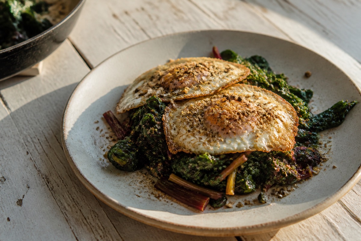 Brown butter greens with fried eggs & dukkah